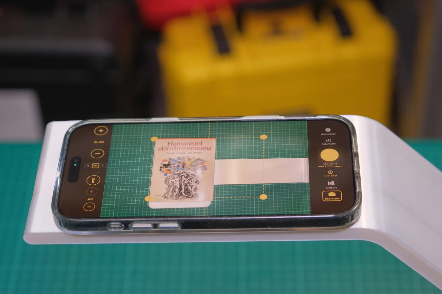 Knut scanning stand with iPhone mounted, scanning an open book